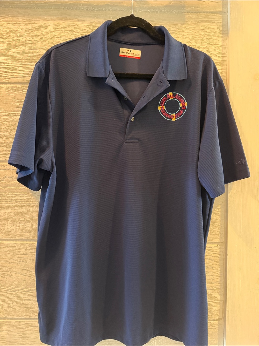 Grand Slam Blue Polo with Embroidered Circular Logo